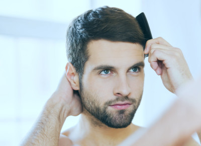 Zufriedener Patient mit vollem Haar nach einer Haaranalyse